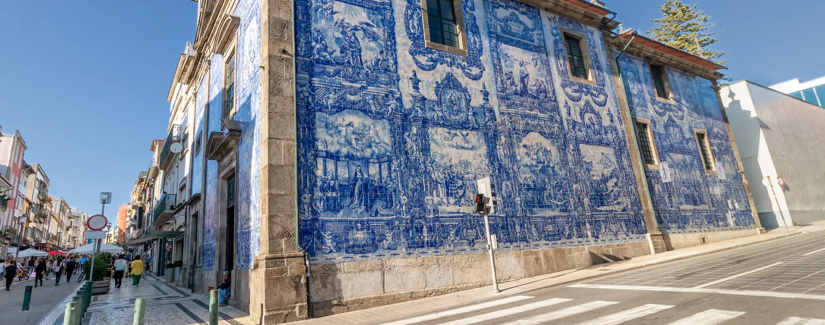 Blue-tiled church in Porto, next to a busy street